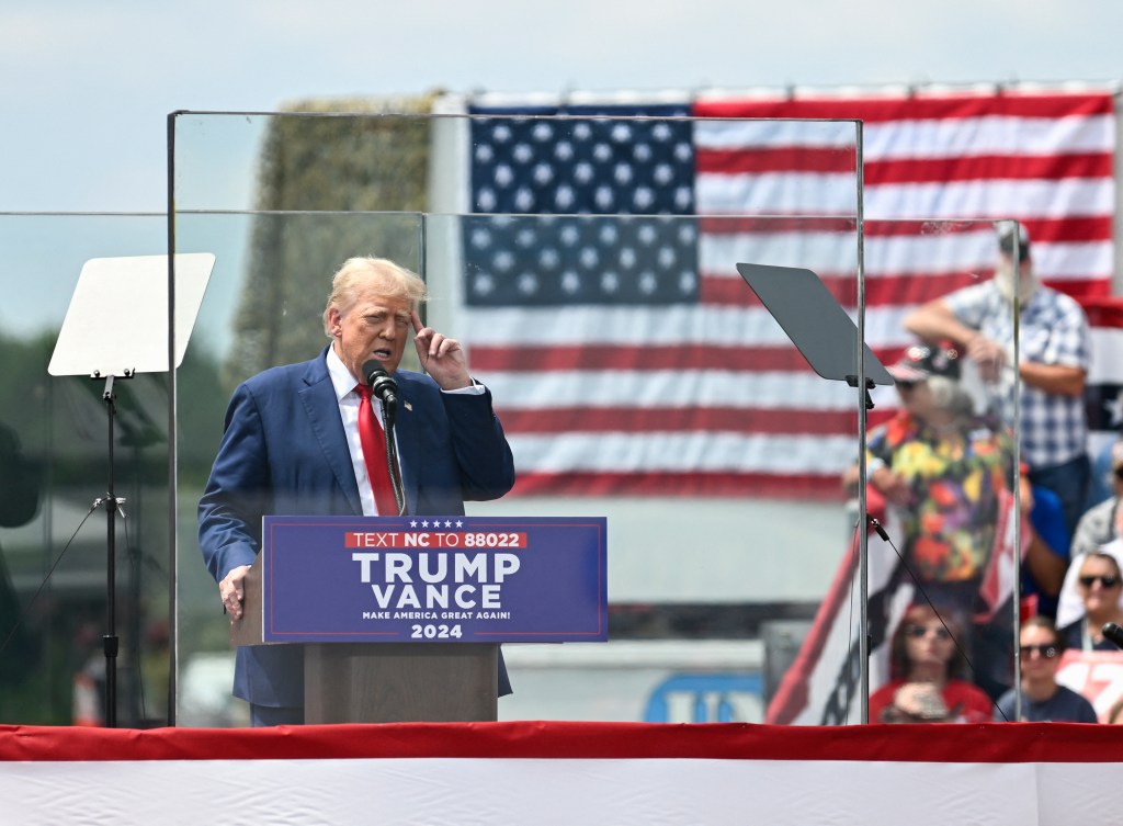 Trump ventures outside of new bulletproof encasement to embrace supporter overcome by heat at North Carolina rally