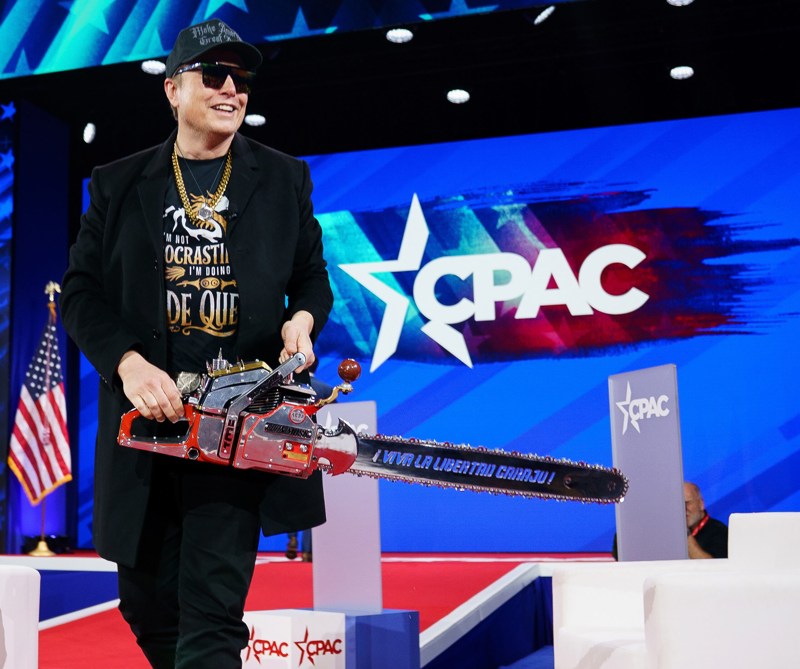 Elon Musk wields ‘chainsaw for bureaucracy’ on stage at CPAC to symbolize DOGE’s massive government cuts